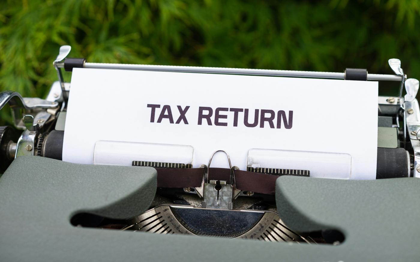 a close up of a typewriter with a tax return sign on it by Markus Winkler courtesy of Unsplash.