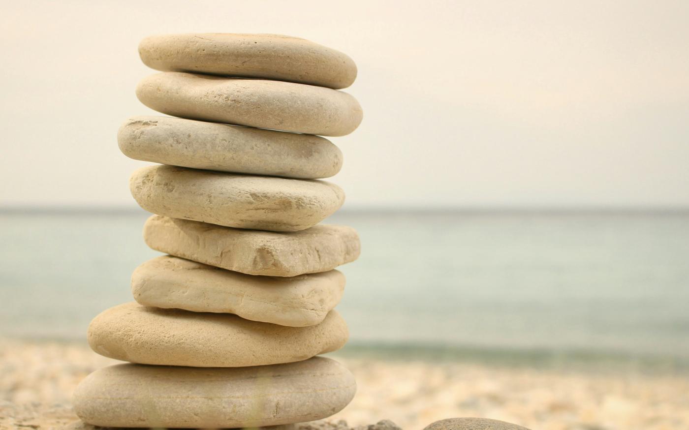 stack white stones on seashore by Iva Rajović courtesy of Unsplash.