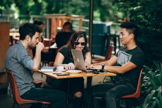 photo of three person sitting and talking by Helena Lopes courtesy of Unsplash.