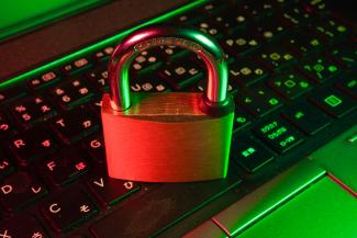 red padlock on black computer keyboard by FlyD courtesy of Unsplash.