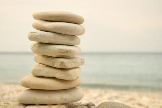 stack white stones on seashore by Iva Rajović courtesy of Unsplash.
