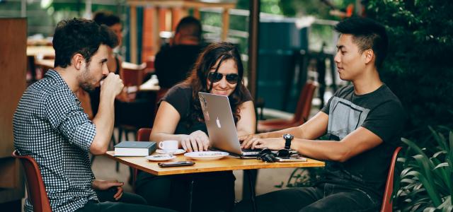 photo of three person sitting and talking by Helena Lopes courtesy of Unsplash.
