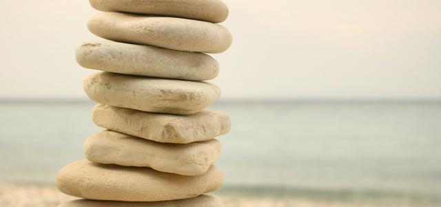 stack white stones on seashore by Iva Rajović courtesy of Unsplash.